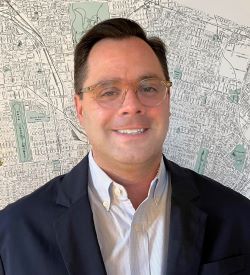 headshot of Andy Hahn with a St Louis streetmap in the background