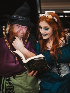 A wizard and a witch enjoy reading a good book.