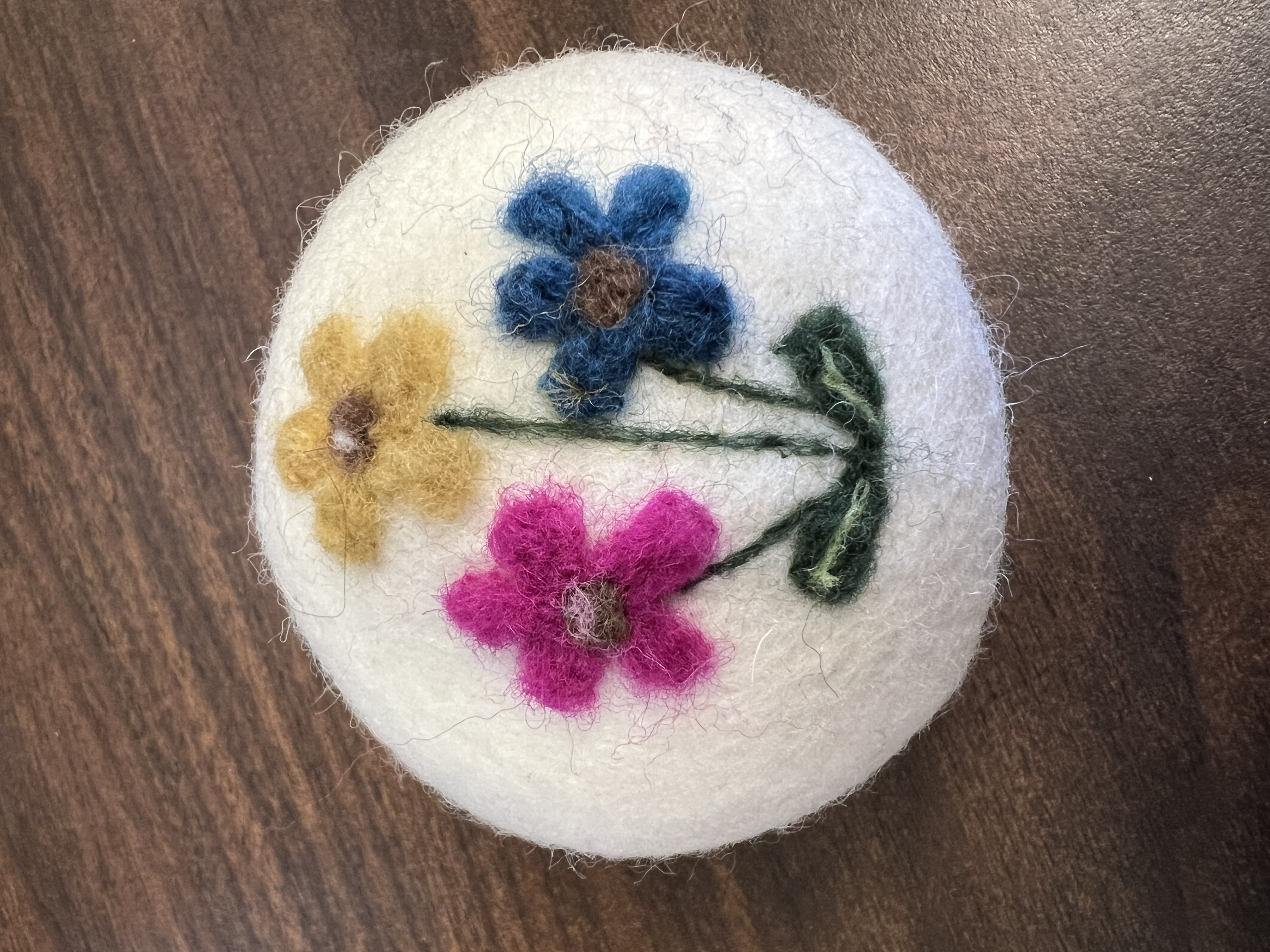 Flowers felted onto wool ball