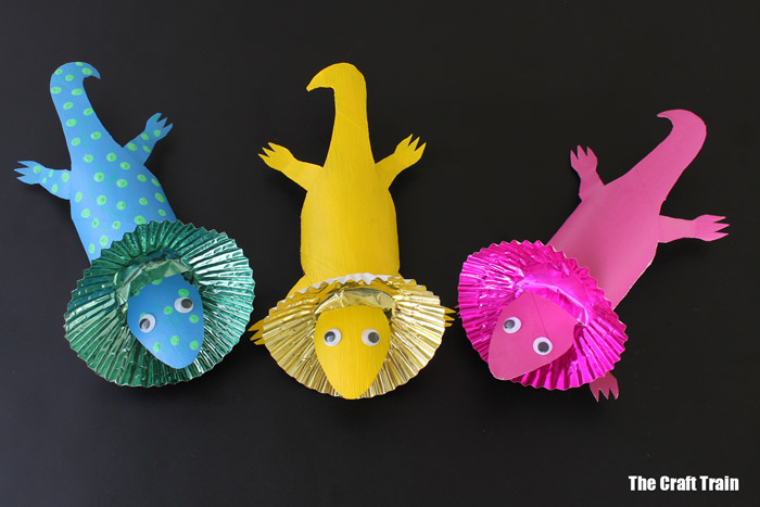 Three paper frilled lizards in different colors