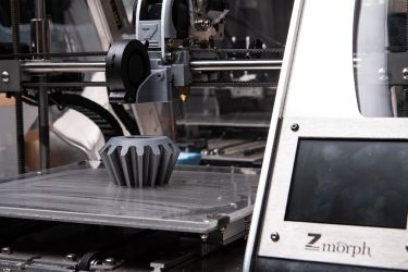 FDM 3D printer printing a cog or gear part