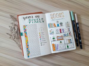 a bullet journal with one page that says year in pixels and the other page says books to read
