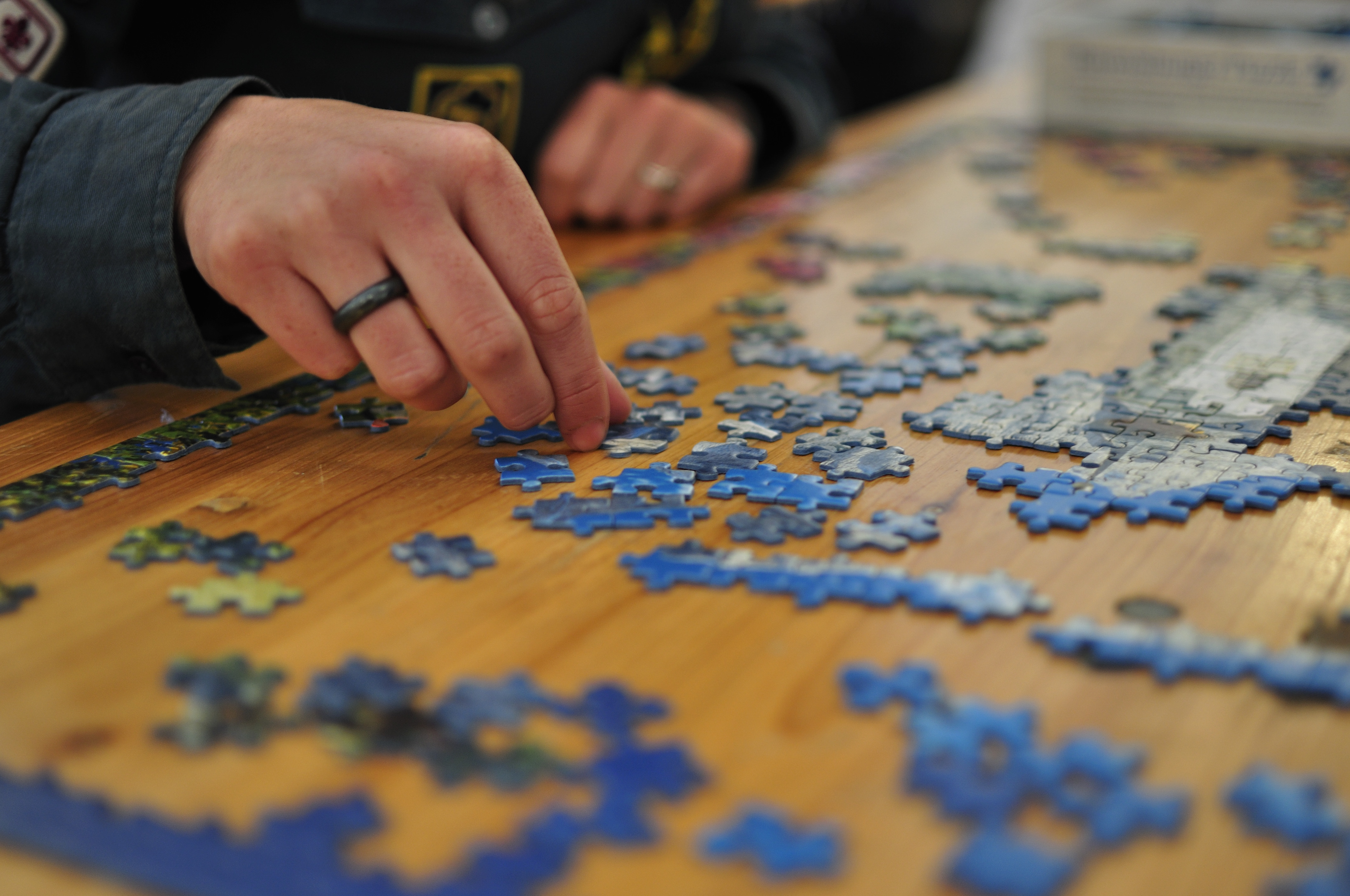 Person working on Jigsaw Puzzle