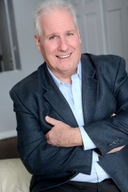 headshot of an older gentleman in a blue suit