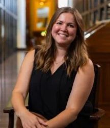 author Caitlin Yager sitting in a chair