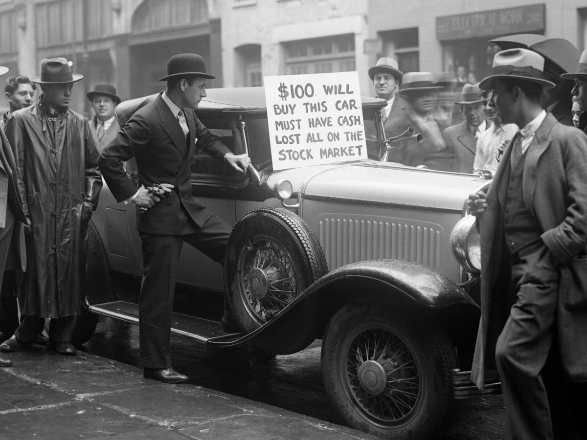 old photo of men standing around a car for sale with a sign on it saying the owner lost everything in the stock market crash