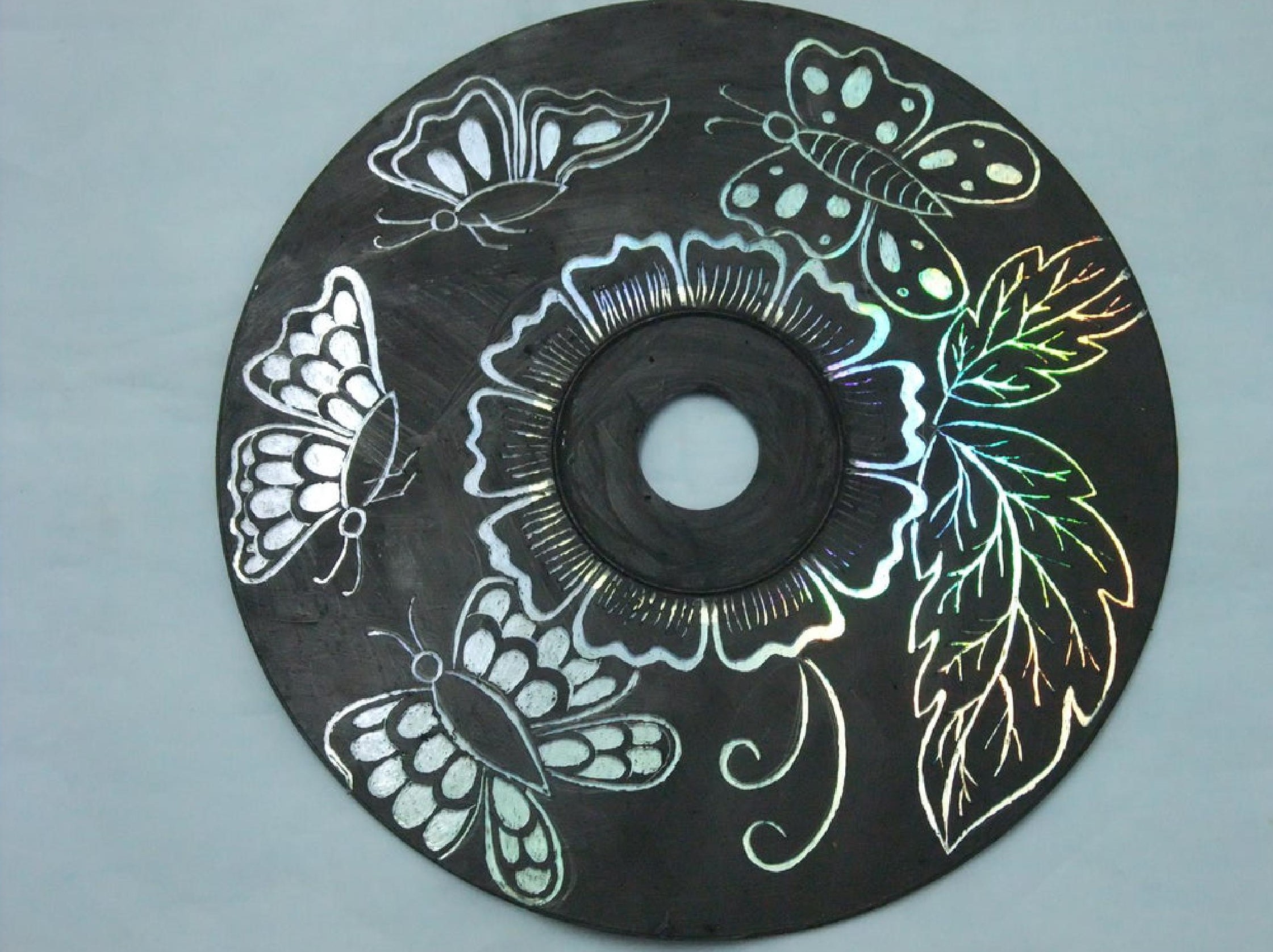 CD with flowery design scraped into the iridescent side of the disc