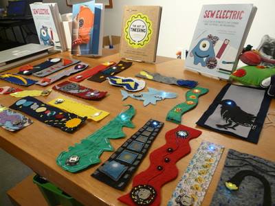 Table with many creative bookmarks with LED lights spread around it.