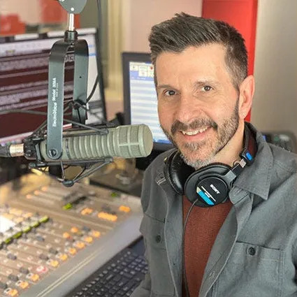 Headshot of man next to a microphone