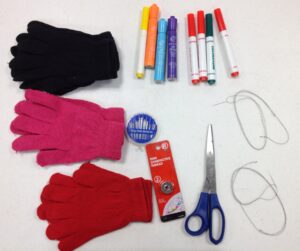 Three pairs of cotton gloves with markers, thread, and scissors. 