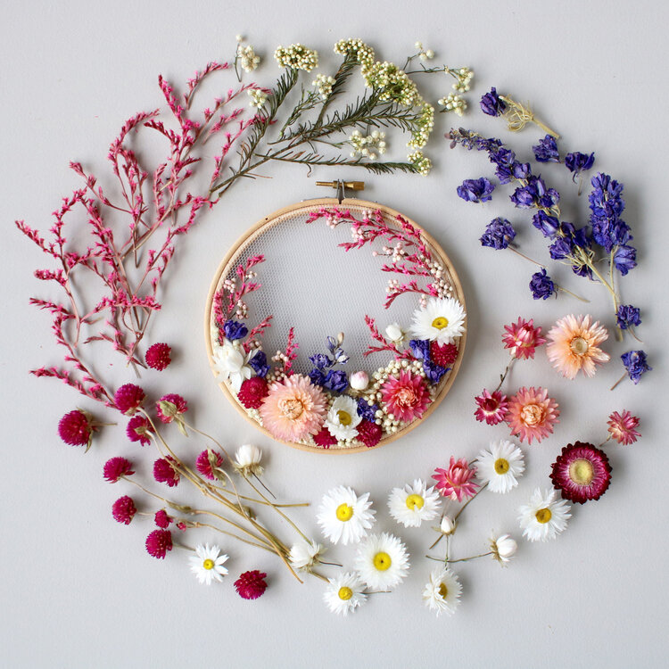 Dried flowers embroidered on tulle in hoop frame