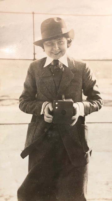 young girl holding a box camera