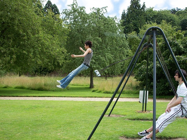 teens swinging at the park