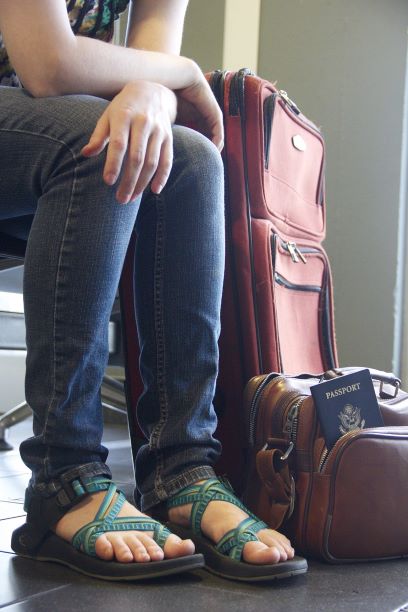 Woman in airport with luggage and password