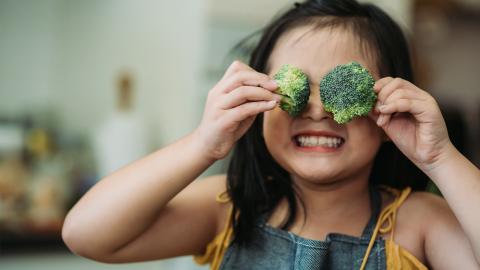 Child holding broccoli