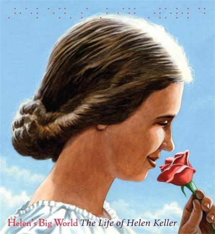 Hellen Keller smiles while sniffing a red rose.