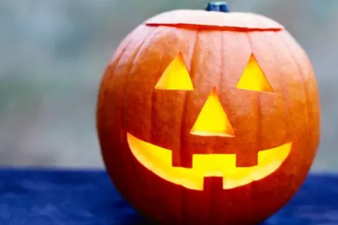 Smiling Jack-O-Lantern on a blue tablecloth