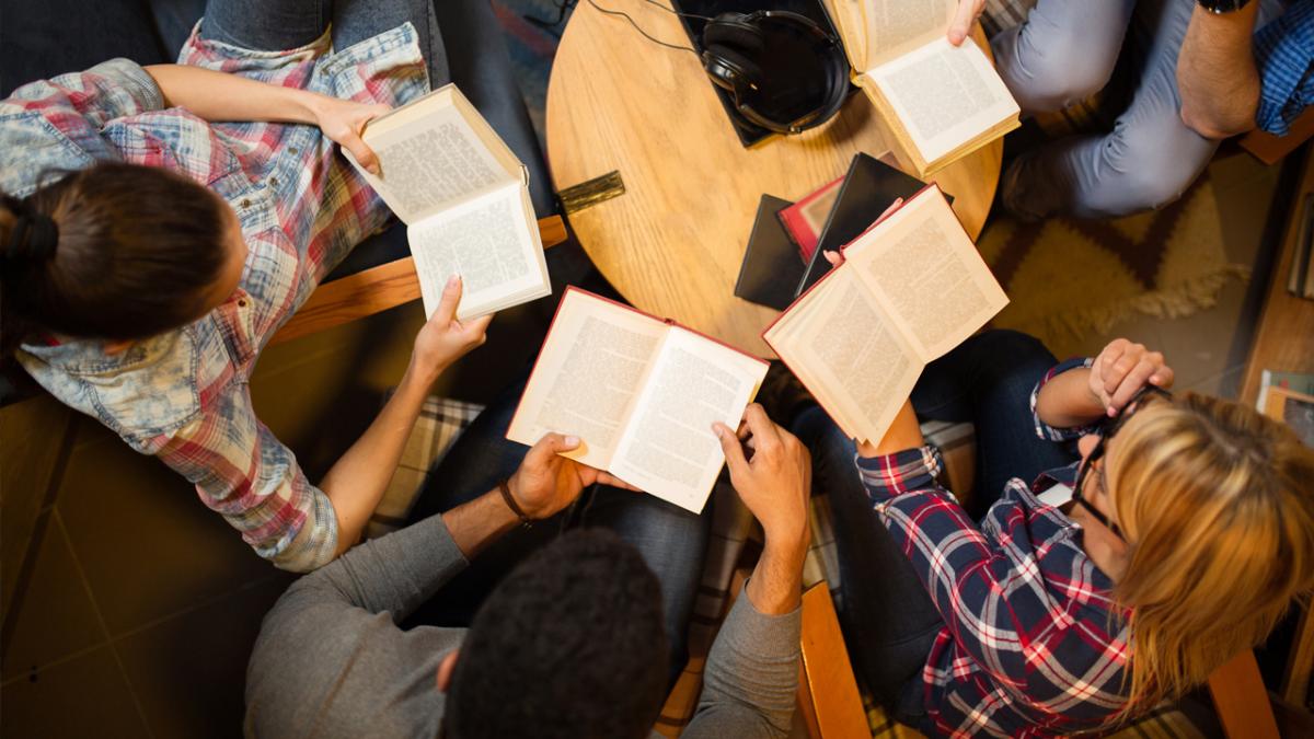 Group of adults holding books