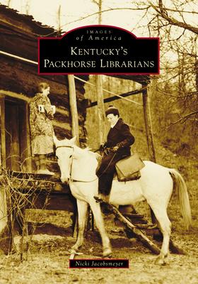 A woman sits on horseback in front of a log cabin. 