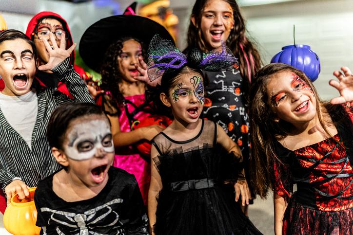 A group of children dressed up in Halloween costumes
