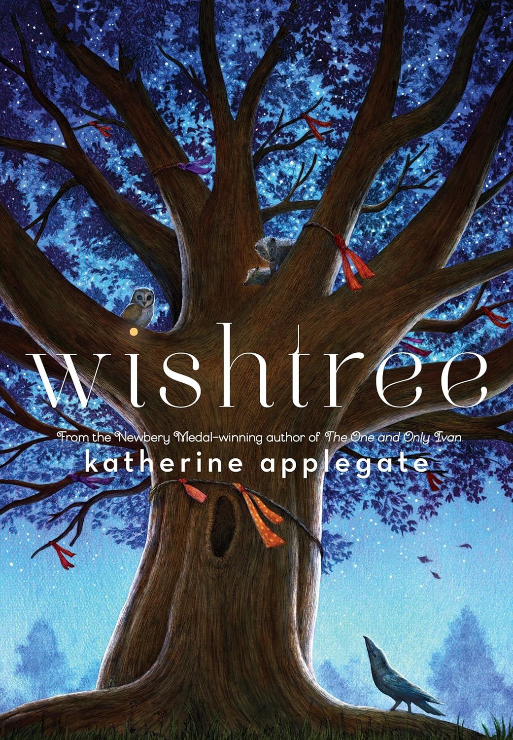 A large tree at night, covered in woodland creatures and ribbons.