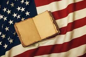 American flag with an aged open book on it